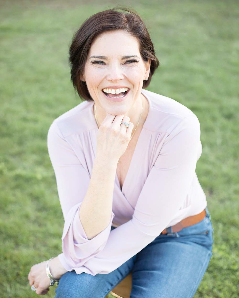 Christine sitting outside, smiling at the camera